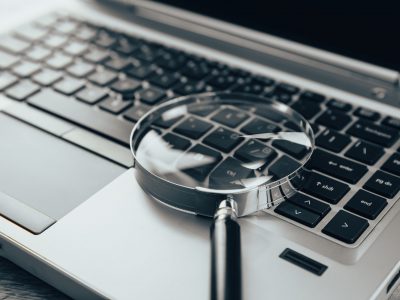 Laptop computer with magnifying glass Laptop computer with magnifying glass, concept of search